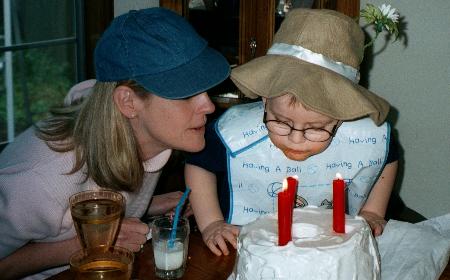 Two Mad Hatters blowing out candles